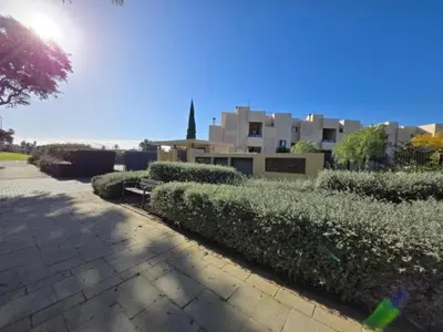a row of hedges in front of some buildings at Atardecer dorado free parking by staycare in Chipiona