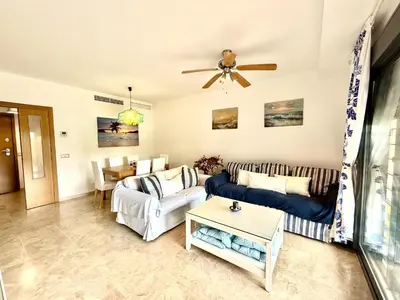 a living room with a couch and a table at Atardecer dorado free parking by staycare in Chipiona