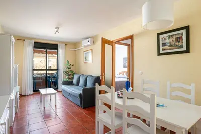 a living room with a table and a couch at aldea 2 5 1ºB in Chiclana de la Frontera