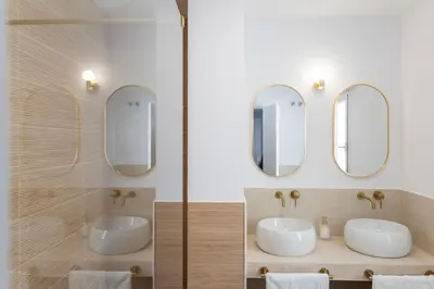 two sinks in a bathroom with two mirrors at GINVA - Apartamento en pleno centro 4 in El Puerto de Santa María