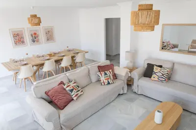 a living room with two couches and a dining table at GINVA - Apartamento en pleno centro 4 in El Puerto de Santa María
