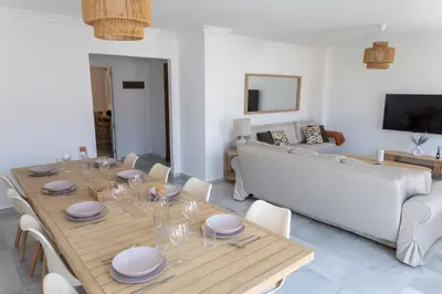 a living room with a table and a couch at GINVA - Apartamento en pleno centro 4 in El Puerto de Santa María