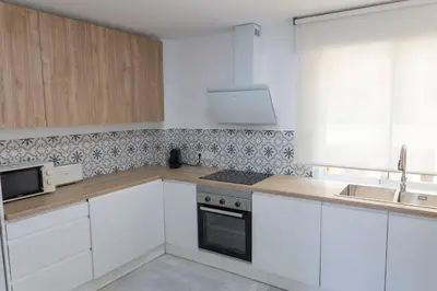 a white kitchen with white cabinets and a sink at GINVA - Apartamento en pleno centro 4 in El Puerto de Santa María