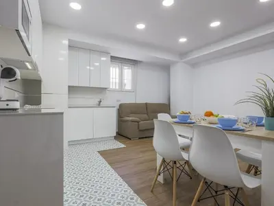 a kitchen and living room with a table and chairs at Playa Caleta in Cádiz