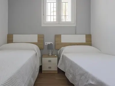 two beds sitting next to each other in a bedroom at Playa Caleta in Cádiz