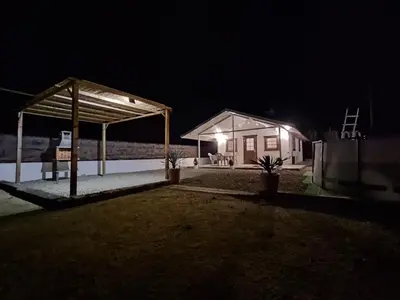 a house with a pavilion at night at Casa El Pinar in Conil de la Frontera