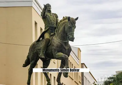 a statue of a man riding a horse in front of a building at Apartalux Playa La Caleta in Cádiz