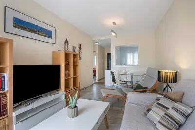 a living room with a large flat screen tv at Magnifico apartamento en la Barrosa frente al mar in Novo Sancti Petri