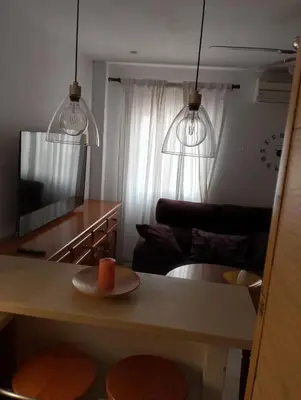 a kitchen with two stools and a table with two lights at Apartamento Acogedor Centro Playa 2habtn,AA-WIFI-PARKING GRATIS CALLE in Sanlúcar de Barrameda