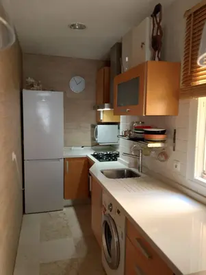 a kitchen with a white refrigerator and a sink at Apartamento Acogedor Centro Playa 2habtn,AA-WIFI-PARKING GRATIS CALLE in Sanlúcar de Barrameda