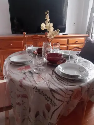 a table with plates and glasses on top of it at Apartamento Acogedor Centro Playa 2habtn,AA-WIFI-PARKING GRATIS CALLE in Sanlúcar de Barrameda