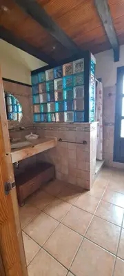 a bathroom with a sink and a tiled floor at Casa Bambú de Luna in Chiclana de la Frontera