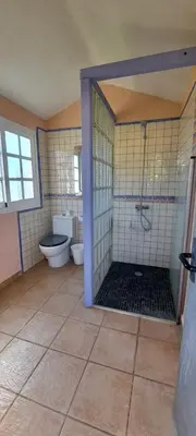 a bathroom with a shower and a toilet in a room at Casa Bambú de Luna in Chiclana de la Frontera
