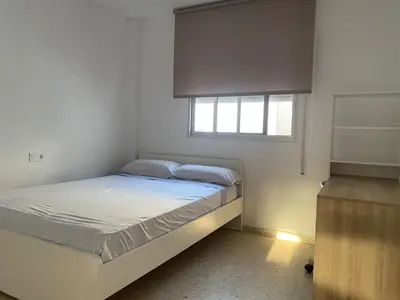 a small bedroom with a bed and a window at Great apartment in Puerto Real in Puerto Real