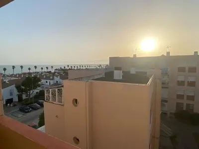 a view of the ocean from a balcony of a building at Great apartment in Puerto Real in Puerto Real