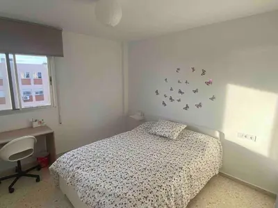 a bedroom with a bed and a desk and a window at Great apartment in Puerto Real in Puerto Real