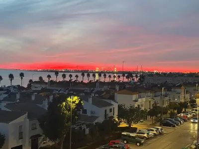 a view of a city with a red sunset at Great apartment in Puerto Real in Puerto Real