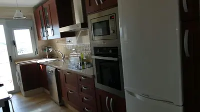 a kitchen with a white refrigerator and a microwave at Great apartment in Puerto Real in Puerto Real