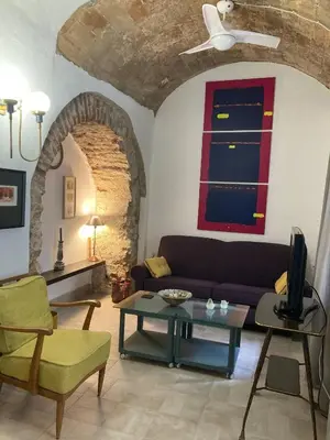 a living room with a couch and a table at Charming 1900 Andalusian Apartment in Arcos de la Frontera in Arcos de la Frontera