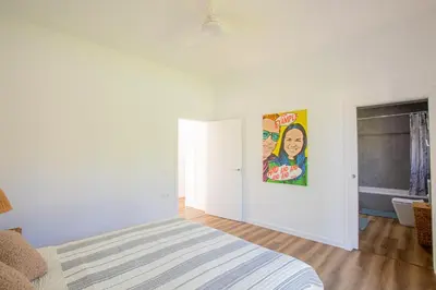 a bedroom with a bed and a poster on the wall at Jardines Fenicios Luxurious and Spacious Villa in Novo Sancti Petri