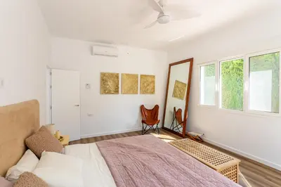 a white bedroom with a bed and a window at Jardines Fenicios Luxurious and Spacious Villa in Novo Sancti Petri
