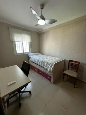 a bedroom with a bed and a table and a desk at Velo de Flor Jerez Apartment in Jerez de la Frontera
