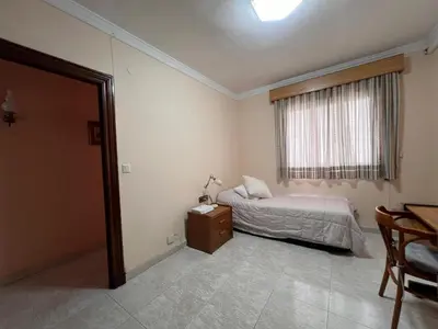 a bedroom with a bed and a window and a table at San José Playa Family Home in Cádiz