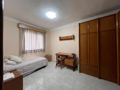 a bedroom with a bed and a desk and a table at San José Playa Family Home in Cádiz