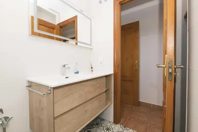 a bathroom with a sink and a mirror at Novo Golf Chiclana in Chiclana de la Frontera