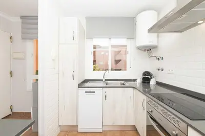 a white kitchen with a sink and a window at Novo Golf Chiclana in Chiclana de la Frontera