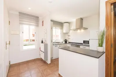 a kitchen with white walls and a counter top at Novo Golf Chiclana in Chiclana de la Frontera