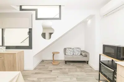 a living room with a couch a chair and a tv at Apartamento Tom-Isi in Rota