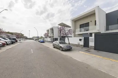 an empty street with cars parked in a parking lot at Apartamento Tom-Isi in Rota
