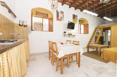a kitchen and dining room with a table and chairs at Loft Santiago in Jerez de la Frontera
