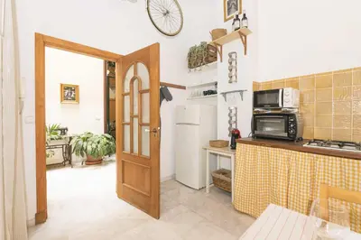 a kitchen with a refrigerator and a microwave at Loft Santiago in Jerez de la Frontera