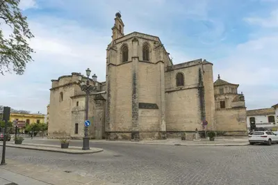 an old stone church with a tower on a street at Loft Santiago in Jerez de la Frontera