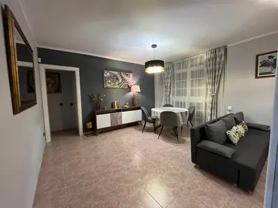 a living room with a couch and a table at Apartamento Luz de Chiclana by Come2Cádiz in Chiclana de la Frontera