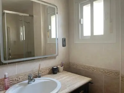 a bathroom with a sink and a mirror at Apartamento Luz de Chiclana by Come2Cádiz in Chiclana de la Frontera