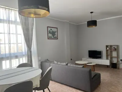 a living room with a couch and a table at Apartamento Luz de Chiclana by Come2Cádiz in Chiclana de la Frontera