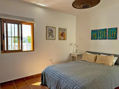 a bedroom with a bed and a window at Casa Alba de Abades - Ole Solutions in Jerez de la Frontera