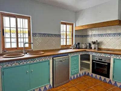 a kitchen with blue cabinets and a counter top at Casa Alba de Abades - Ole Solutions in Jerez de la Frontera
