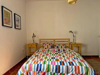 a bedroom with a colorful bed with two night stands at Casa Alba de Abades - Ole Solutions in Jerez de la Frontera