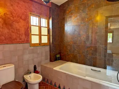 a bathroom with a tub and a toilet and a sink at Casa Alba de Abades - Ole Solutions in Jerez de la Frontera