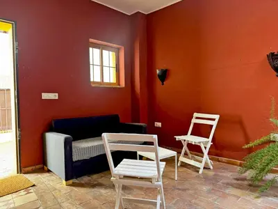 a living room with two chairs and a couch at Casa Alba de Abades - Ole Solutions in Jerez de la Frontera