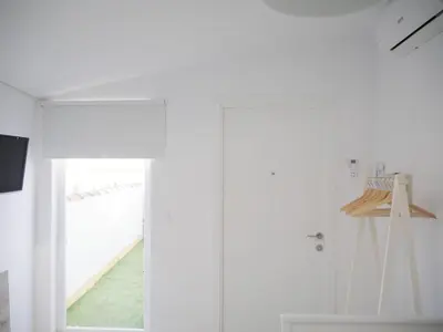 a white room with a sliding door and a staircase at Apartamento con terraza privada in Jerez de la Frontera