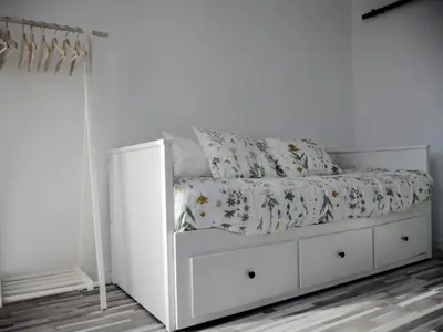 a white bed in a white room with a bed frame at Apartamento con terraza privada in Jerez de la Frontera