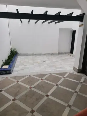 an empty room with a tiled floor with planes on the wall at Apartamento con terraza privada in Jerez de la Frontera