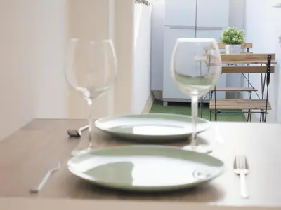 two wine glasses and a plate on a table at Apartamento con terraza privada in Jerez de la Frontera