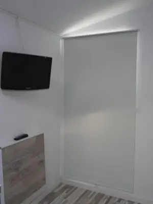 a room with a flat screen tv on a white wall at Apartamento con terraza privada in Jerez de la Frontera