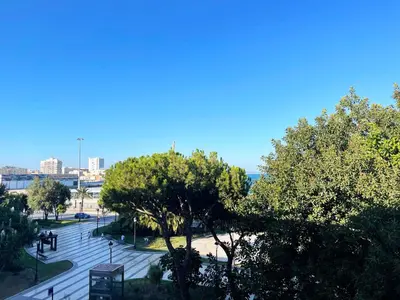 a view of a parking lot with trees and a city at Apartamento Canalejas in Cádiz